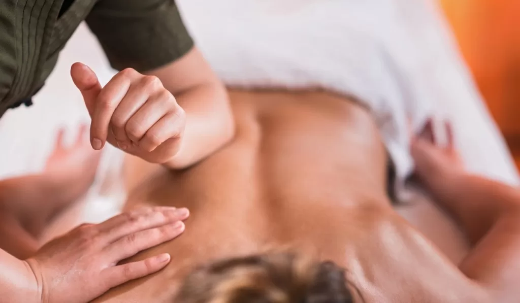 woman massaging a persons back